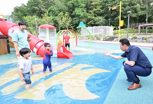 백영현 시장(오른쪽)이 지난 7월5일 일동면 기산근린공원 내 물놀이 시설에서 수영을 하고 있는 아이들에게 손짓을 하고 있다.